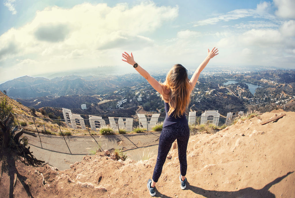 Woman at top of Hollywood sign in Los Angeles
